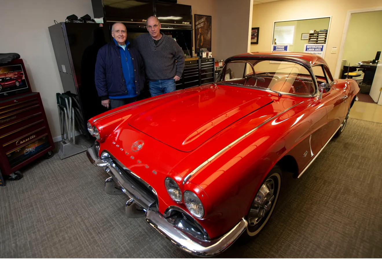 Red classic Corvette inside Billy Bob's Fast Expensive Cars with shop team in the background.