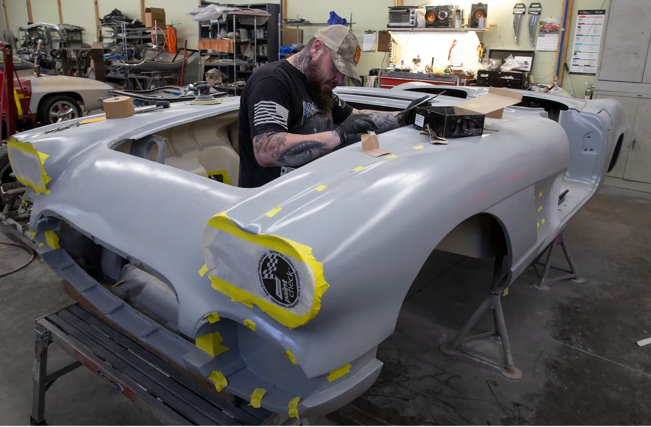 Restoration bodywork in progress on a classic vehicle inside the shop.