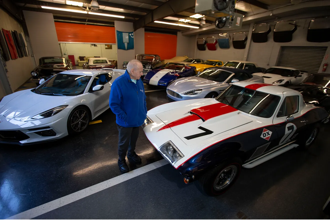Bob Caruso inside Billy Bob's Fast Expensive Cars shop with classic and collector vehicles.